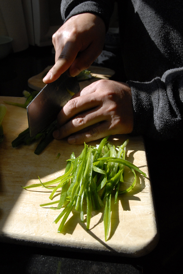John cuts up scallions for the whole fish. Photo: Wendy Goodfriend