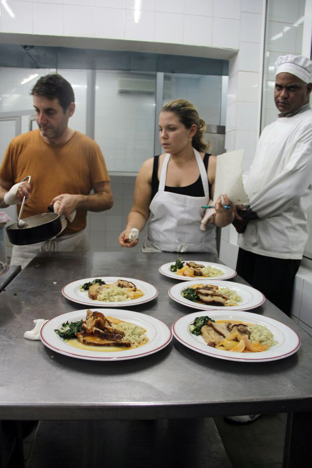 Danielle Alvarez gives plates a final look before sending them out to Cuban diners. Photo: Nina Wolpow