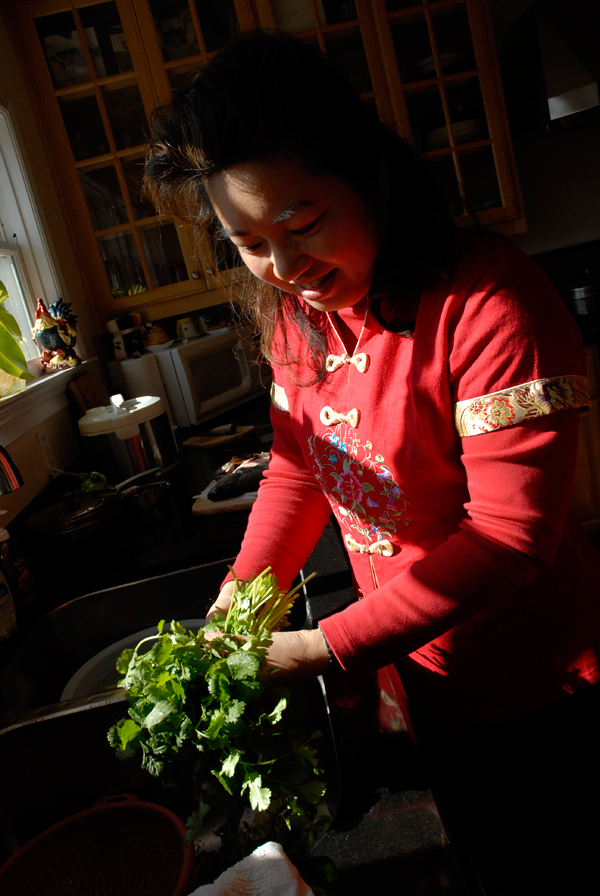 Lisa Li cleans cilantro for whole fish. Photo: Wendy Goodfriend