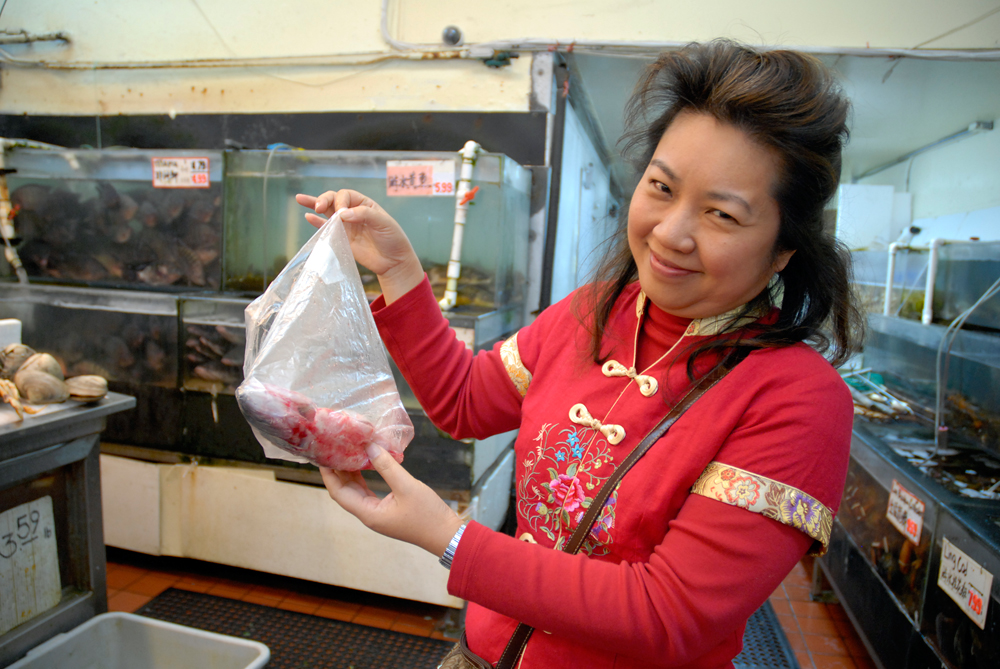 Lisa Li holding sea bass. Photo: Wendy Goodfriend