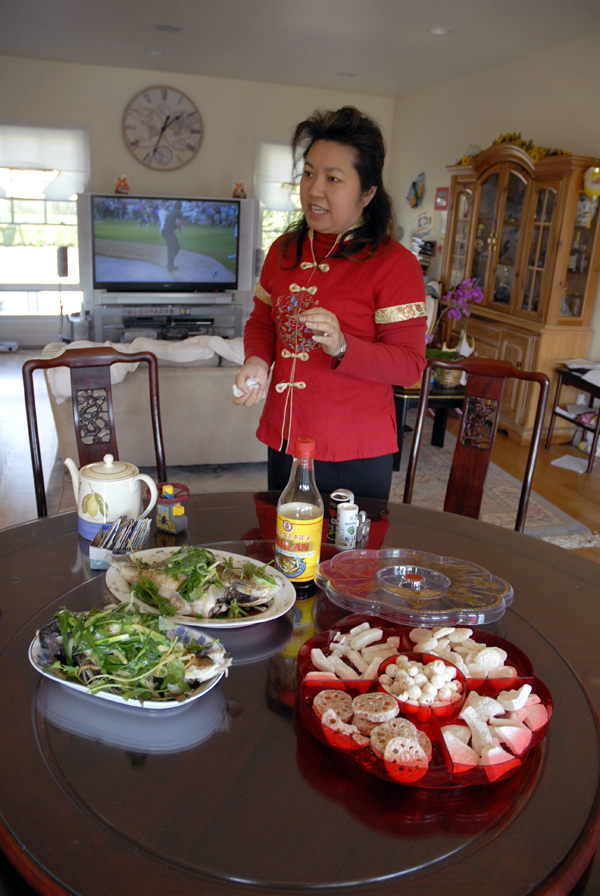 Lisa Li in front of round table with Chinese New Year foods