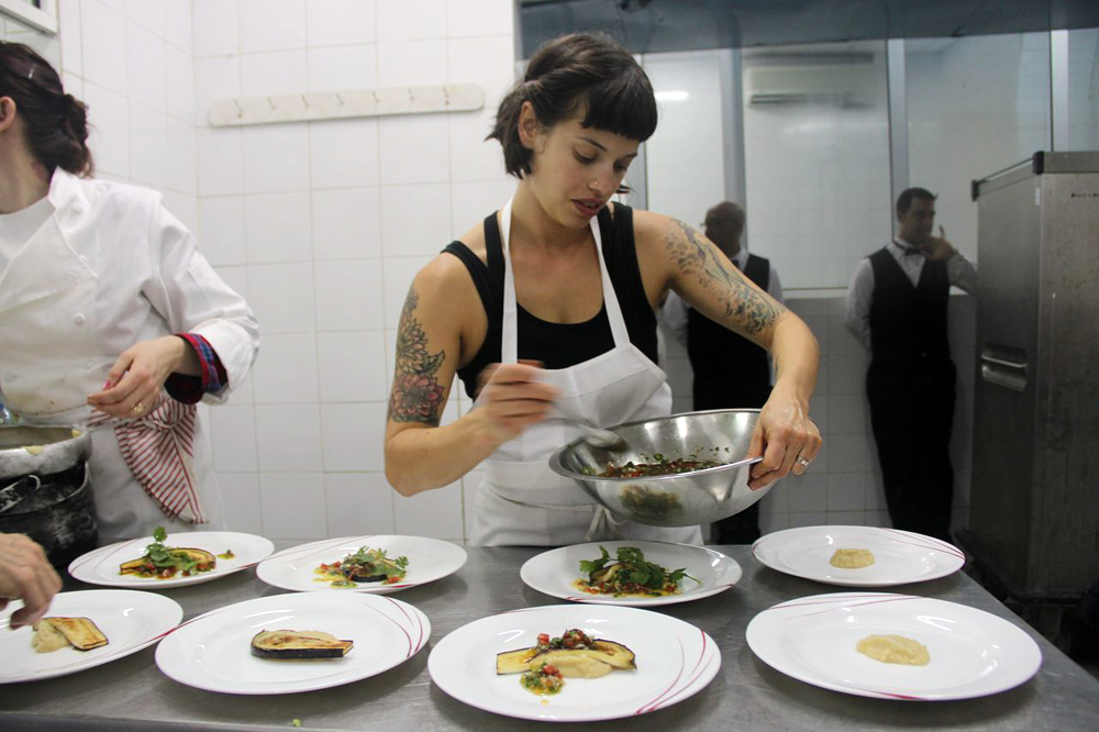 Fellow Cuban-American Melissa Fernandez plates dishes before serving Cuban dignitaries. Photo: Nina Wolpow