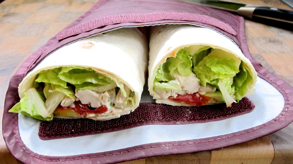 Lavash wrap with roasted chicken, avocado, roasted tomatoes, romaine lettuce and labneh.