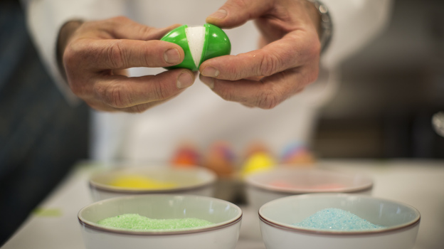 After the marshmallow has set, open the plastic shell and dip the egg in flavored and colored sugar, as Thomas Keller demonstrates here. Photo: Doriane Raiman for NPR