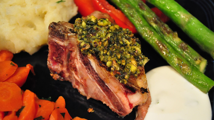 A lamb chop crusted with pistachio, mint and spices, served with assorted vegetables. Photo: Whitney Pipkin for NPR