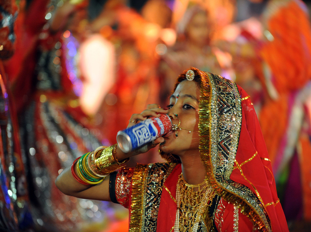 A performer drinks a soda in Ahmedabad, India in 2010. A study found that rising diabetes prevalence in countries like India is strongly tied to sugar consumption. Photo: Sam Panthaky/AFP/Getty Images