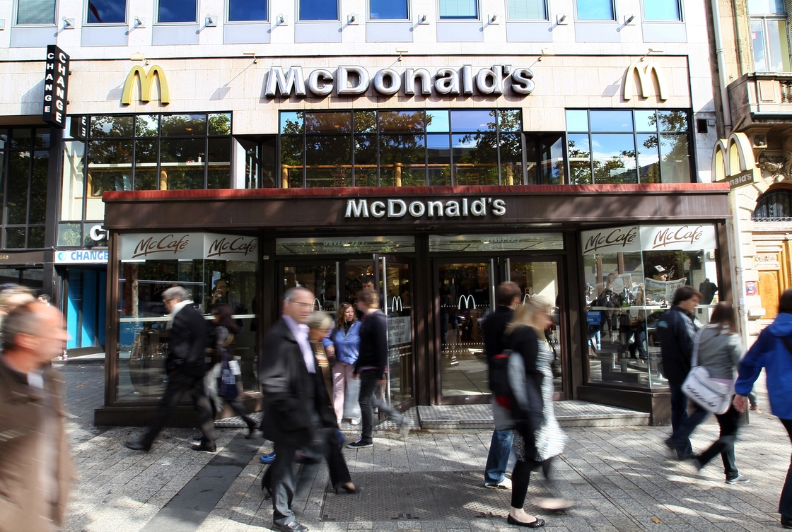 Fast times on the Champs-Elysees: People walk past a McDonald's on one of Paris' most storied avenues. But it's not just McD's that has caught French interest: Fast food now accounts for the majority of restaurant spending in the country. Photo: Thomas Coex/AFP/Getty Images