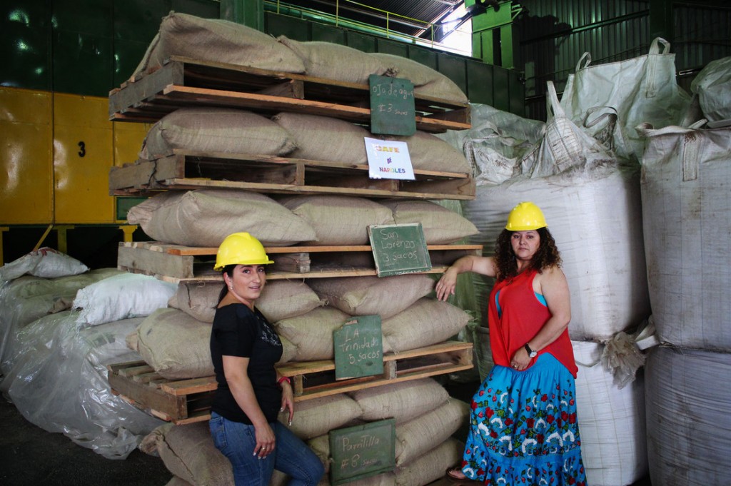 Angelina Zuñiga Godinez and Fanny Cordero Mora grow coffee for Coopetarrazu, one of Costa Rica's largest coffee cooperatives. These bags of coffee are labeled with the towns where they are grow. Photo: Dan Charles/NPR