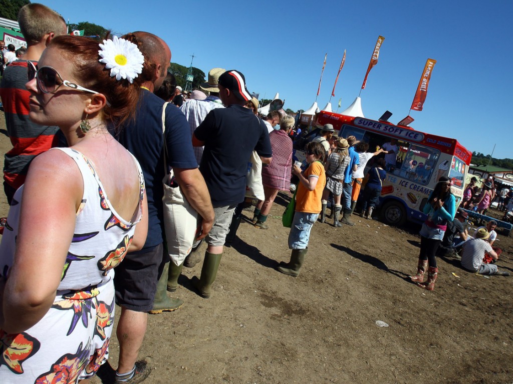 Customers line up for an ice cream van at the 2011 Glastonbury Music Festival in southwest England. Photo: Matt Cardy/Getty Images