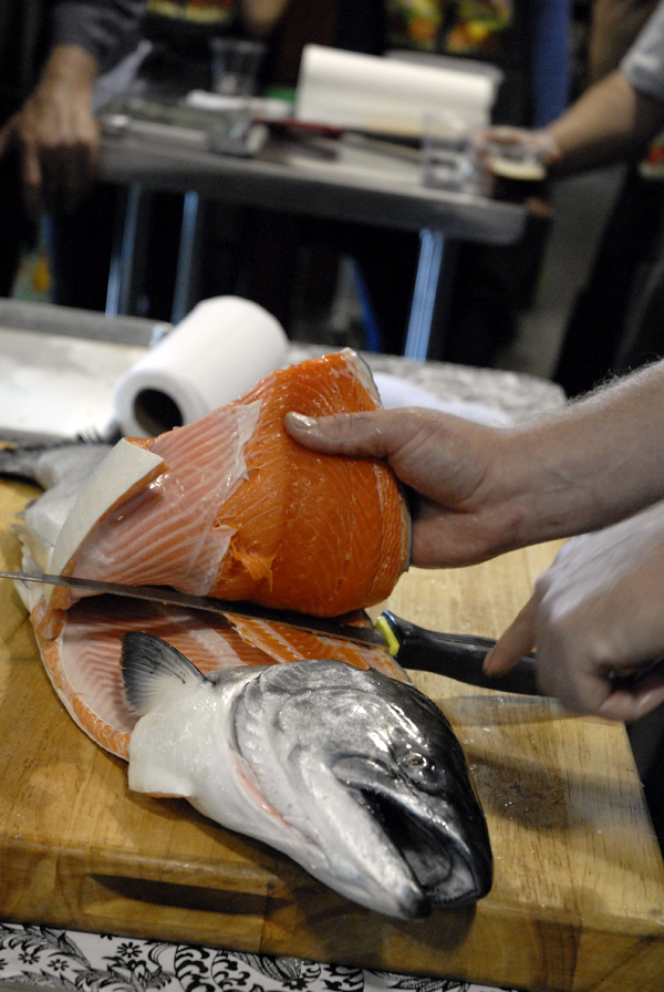 Chef Neil Davidson filleting a whole salmon. Photo: Wendy Goodfriend 
