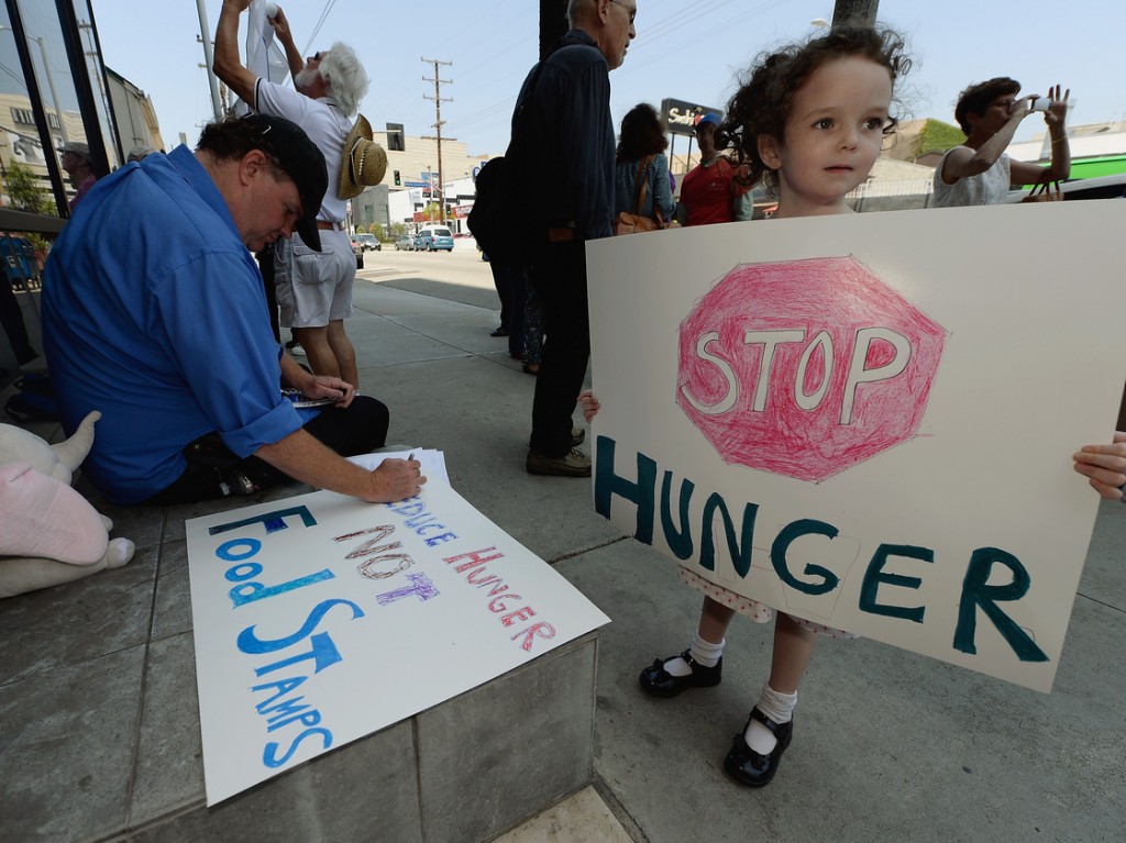 Gracie Shannon-Sanborn, 5, holds a sign as she joins her father Allen Sanborn (L) and members of Progressive Democrats of America at a rally in front of Rep. Henry Waxman's office on June 17, 2013 in Los Angeles, Calif. The protestors asked the congressman to vote against a House farm bill, which was defeated Thursday. Photo: Kevork Djansezian/Getty Images