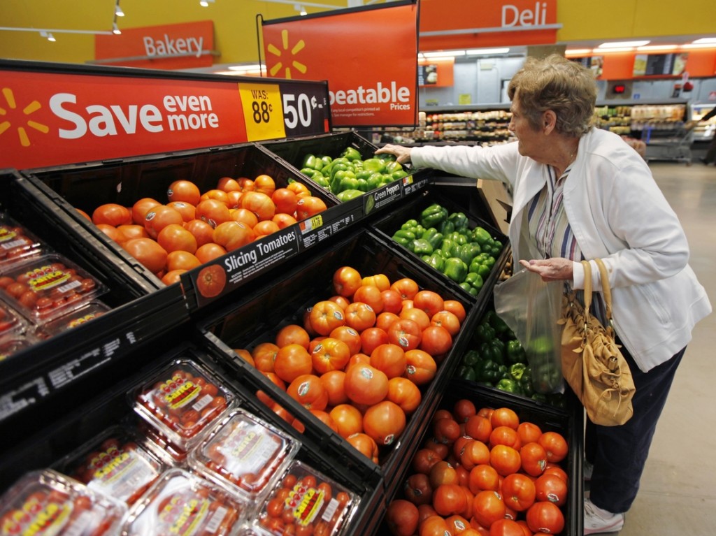 A shopper selects produce at a Wal-Mart in Deptford, N.J. Photo: Matt Rourke/AP