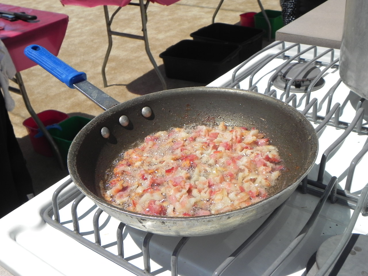 Bacon sizzles in the pan. It became part of the bacon jam used in lobster dish. Photo: Gina Scialabba