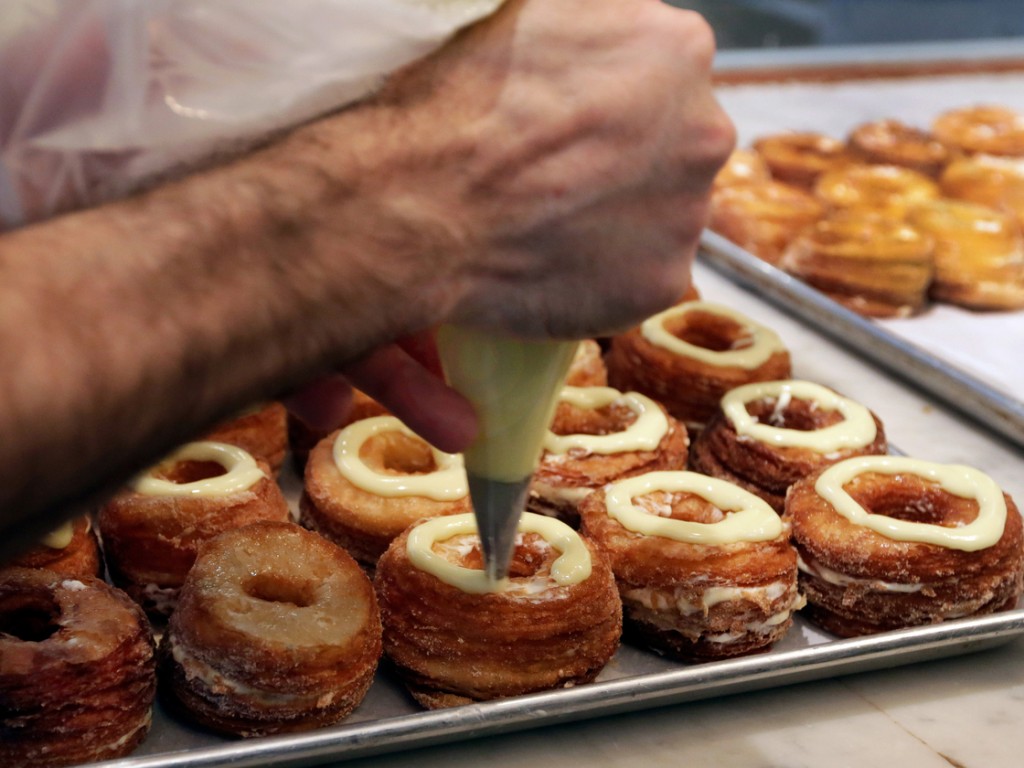 Chef Dominique Ansel makes cronuts, a croissant-donut hybrid, at his New York bakery in June. Photo: Richard Drew/AP