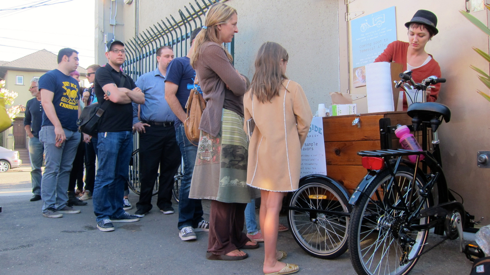 Curbside Creamery's Tori Wentworth dishes out free samples at a recent First Friday event held in Oakland's Temescal Alley