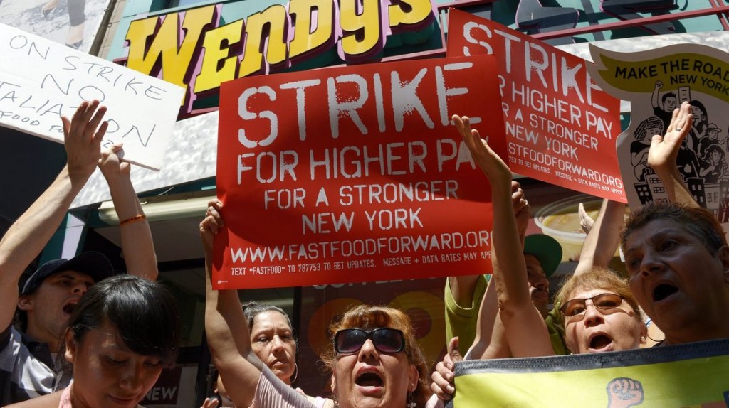 People gathered outside a Wendy's restaurant in New York City on Monday as part of a one-day strike calling for higher wages for fast-food workers. Photo: Justin Lane/EPA/Landov