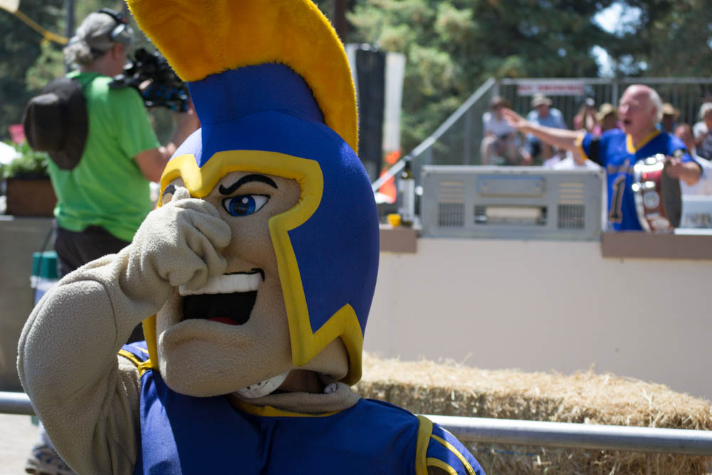 San Jose State University’s mascot, The Spartan, plugs his nose as “Krazy” George Henderson, right, instructs the audience to do the same at the inaugural Garlic Bowl cook-off at the Gilroy Garlic Festival. Henderson claims to have invented “the wave,” which is now ubiquitous at sporting events.  Photo: Sara Bloomberg