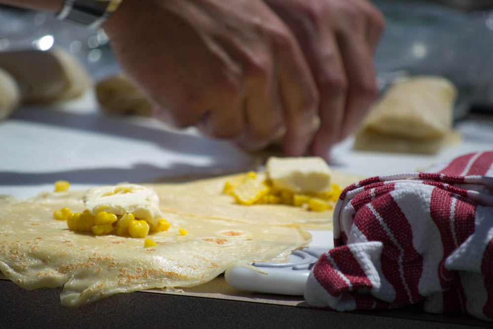 Chef Erik Debaude prepares corn and St. André stuffed crepes with a tarragon and lavender garlic cream sauce during the Garlic Bowl cook-off at the Gilroy Garlic Festival. Photo: Sara Bloomberg