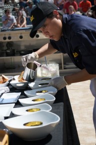 Chef Mary Ferrer from the University of California, Berkeley adds a garlic nage (a broth and wine based liquid) to dish during the Garlic Bowl cook-off at the Gilroy Garlic Festival. Photo: Sara Bloomberg