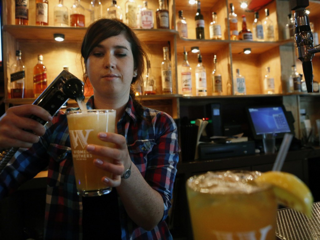 Megan Horrigan mixes a shandy at Washington, D.C.'s Union Pub."It's refreshing, great for the summer," says local customer Tom Tupa, who sampled the drink. Photo: Heather Rousseau/NPR