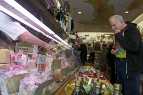 Christopher Lane tries some cheese at Lucca. He’s been a loyal customer for about 40 years. Photo by Sara Bloomberg