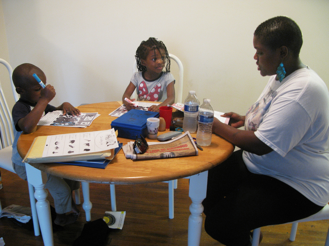 Losia Nyankale helps daughter Jonessa and son Juliean learn the alphabet. Nyankale, who works in a restaurant in Washington, D.C., says she needs food stamps and child-care subsidies to make ends meet. Photo: Jennifer Ludden/NPR