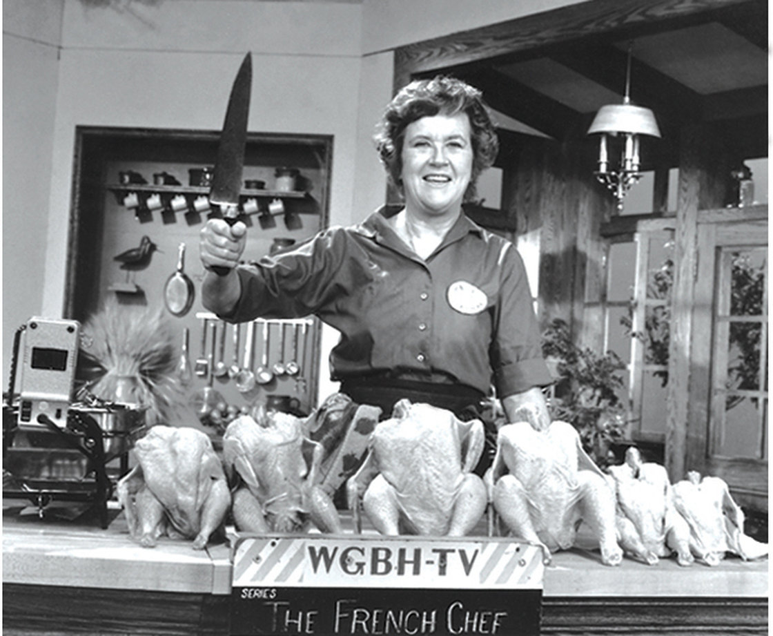 Julia Child poses with "the chicken sisters" before an episode of The French Chef in which she teaches us how to roast a bird. Photo: Courtesy of Paul Child/PBS