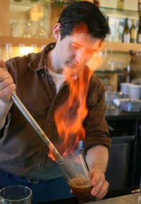 Flip back in time: Chef David Arnold mixes up a drink with a blazing-hot metal rod, a method similar to how bartenders used to make the flip cocktails that were wildly popular in colonial New England. Photo: Courtesy of Sam Meyer