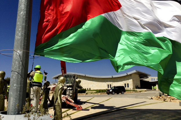Palestinian flags at the top of Rawabi, where residents are planning to move in shortly. Photo: Emily Harris/NPR