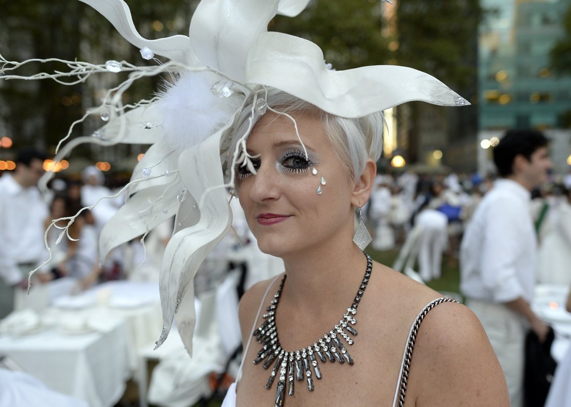 Many guests see Diner en Blanc as an occasion to unleash their fashion whimsy. The event is always held outdoors, always at a landmark location revealed at the last-minute. Here, a guest at the Bryant Park event last week. Photo: Timothy Clary/AFP/Getty Images