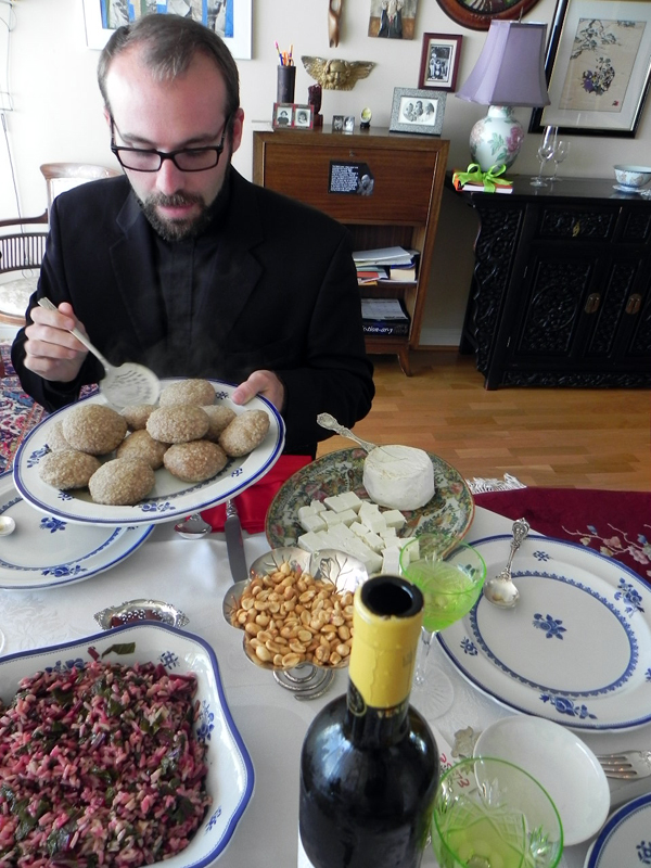 All in a day's work: Father Mesrop Ash of St. John’s Armenian Apostolic Church in San Francisco stacks his plate with kufta. The Armenian version is a lamb meatball stuffed within a lamb meatball. Photo: Gina Scialabba