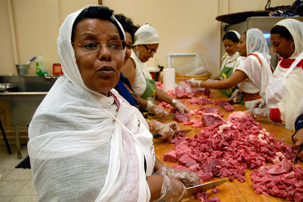 Women in the church kitchen prepare the meat for the festival's meal. Photo: Wendy Goodfriend
