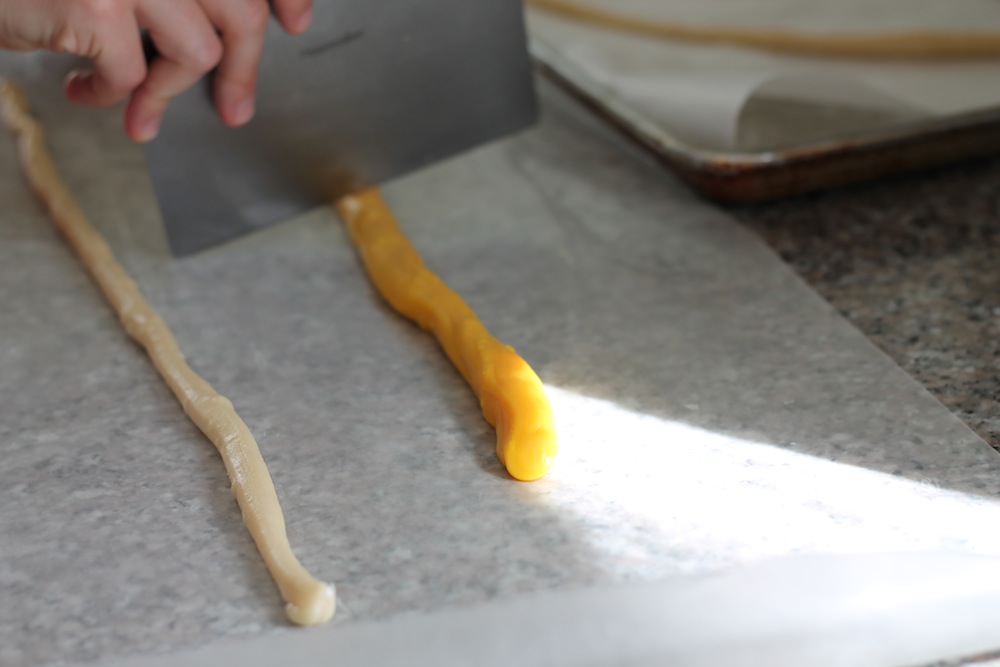 Rolling the dough into snakes on parchment paper helps to prevent sticking. Photo: Katy Sosnak.