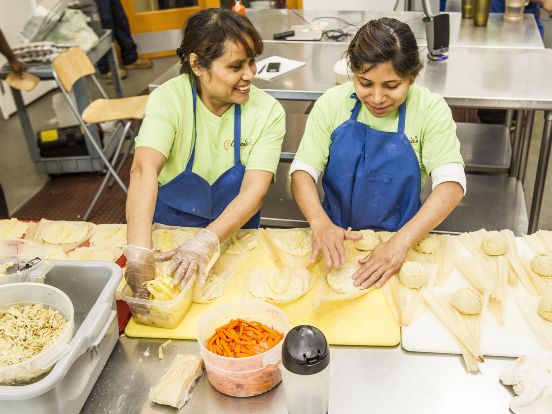 Two employees of Alicia's Tamales los Mayas prepare tamales in the La Cocina industrial kitchen. Alicia Villanueva, the owner, and her team produce 3,000 to 5,000 tamales every week to sell in the Bay Area. Photo: Courtesy of La Cocina