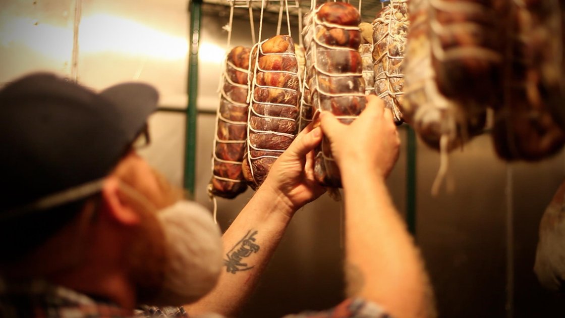 Brent Gentry of Underground Meats rotates a coppa. Underground Meats is behind a new project that aims to lower the barrier to entry for would-be artisanal meat producers by making it easier for them to craft food safety plans. Photo: Emily Julka/Courtesy of Underground Meats