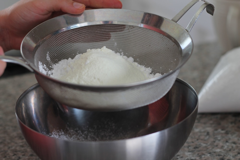 Sifting the confectioners’ sugar and dry milk powder will help prevent clumps in the final candies. Photo: Katy Sosnak.