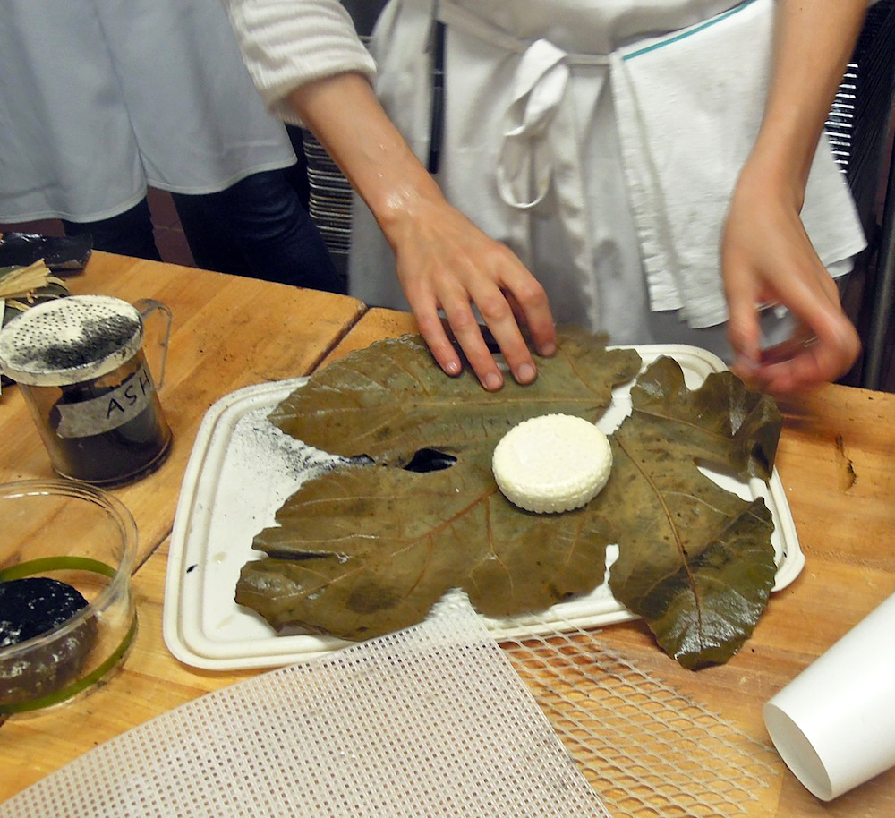  Wrapping goat cheese in booze-soaked fig leaf. Photo: Anna Mindess
