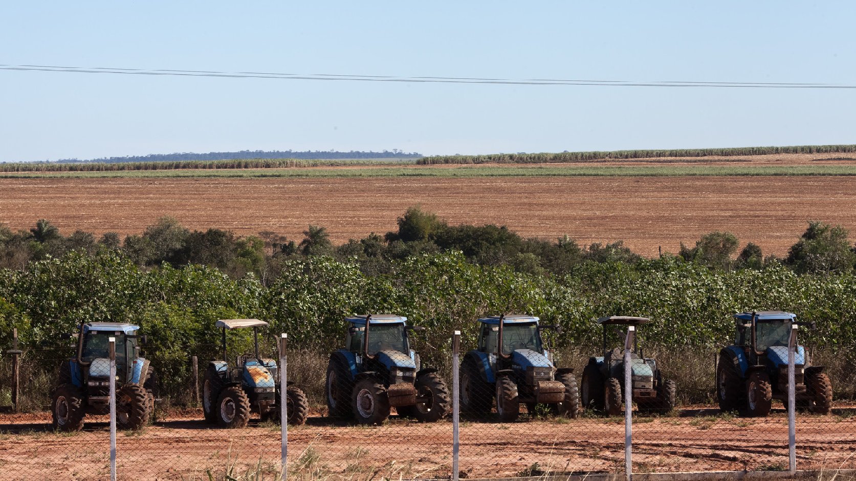 Tractors sit on a sugarcane plantation occupying the  land of a Guarani-kaiowá indigenous community in Brazil. Photo: Tatiana Cardeal/Courtesy Oxfam