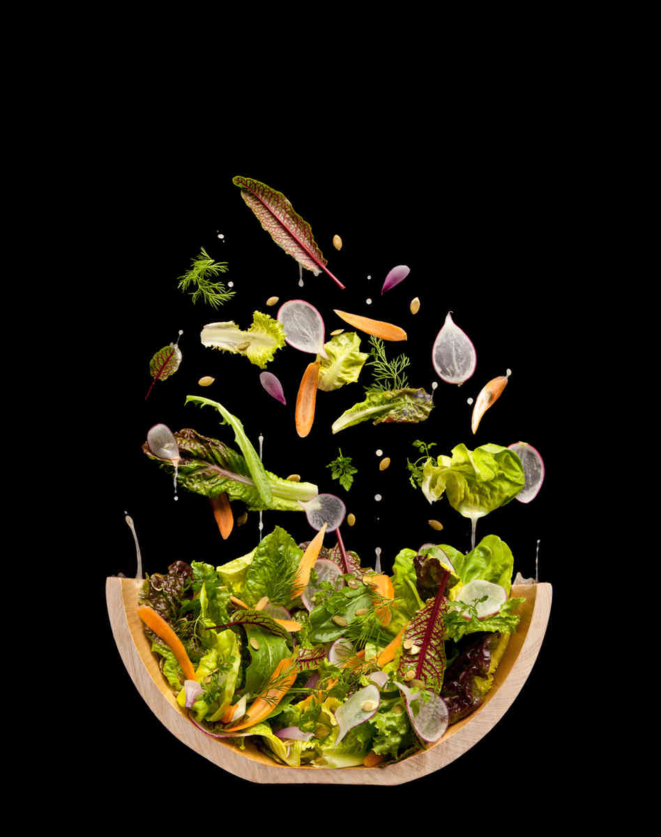 A tossed salad that isn't tossed. The photographers hung a piece of black velvet at a 70 degree angle and then pinned the leaves and nuts in place. Photo: Courtesy of The Cooking Lab