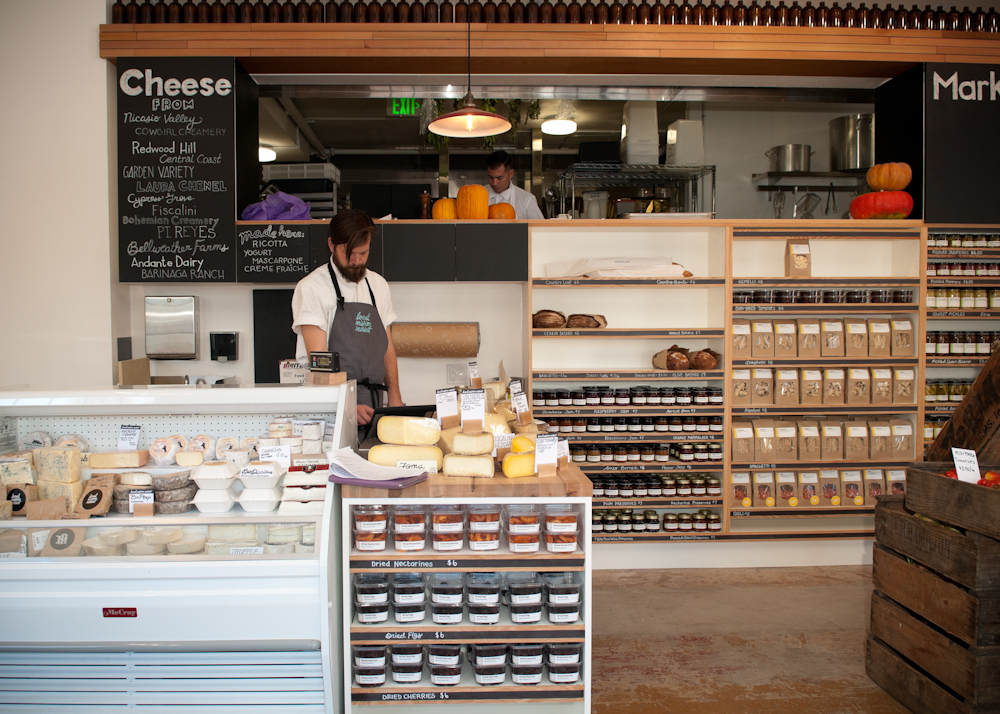 Cheese counter, pickles and fresh pasta shelves with view of kitchen. Photo: Naomi Fiss