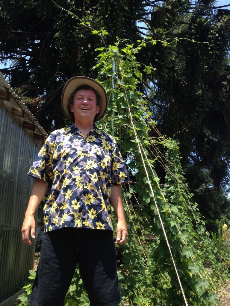 Cabrera poses next to the vines that grew nearly 40-feet-high this summer. Photo: Mark Cabrera