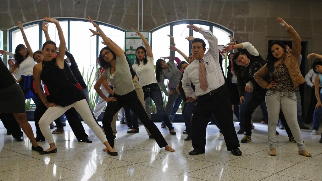 Government workers exercise at their office in Mexico City, August 2013. To counter the obesity epidemic, the city requires all government employees to do at least 20 minutes of exercise each day. Photo: Tomas Bravo/Reuters /Landov