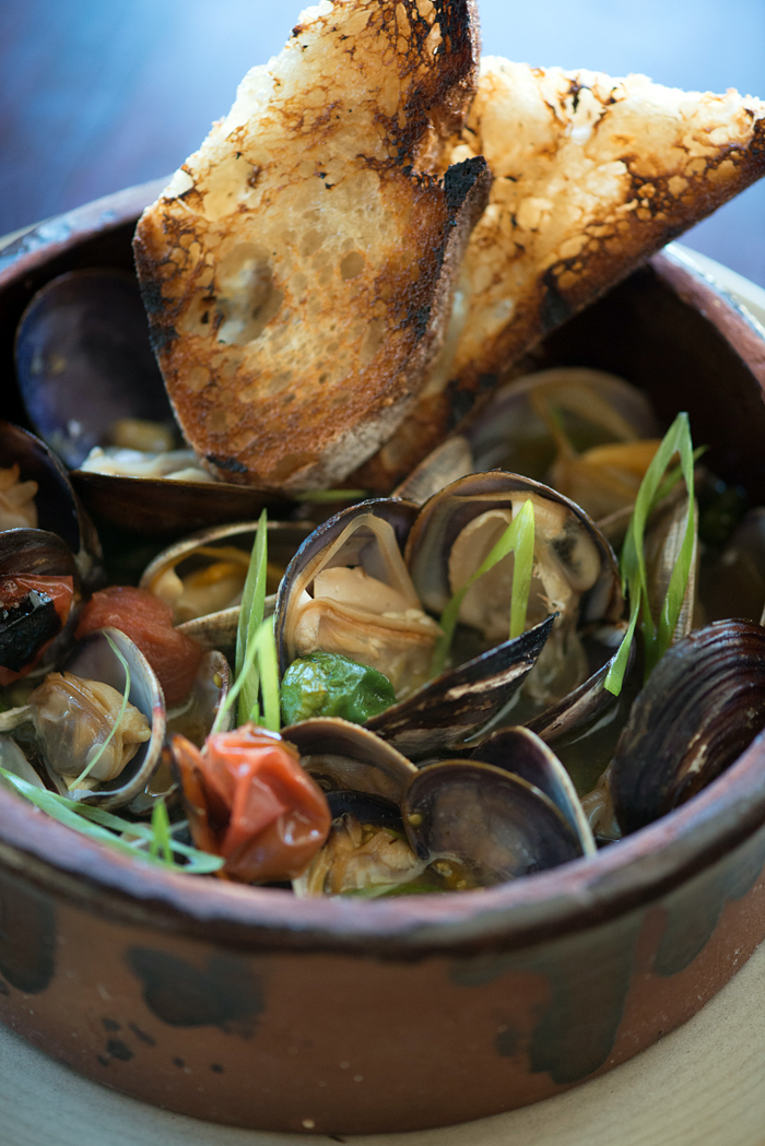 Fog City wood oven clams with sake butter, padrones and cherry tomatoes. Photo: Kristen Loken