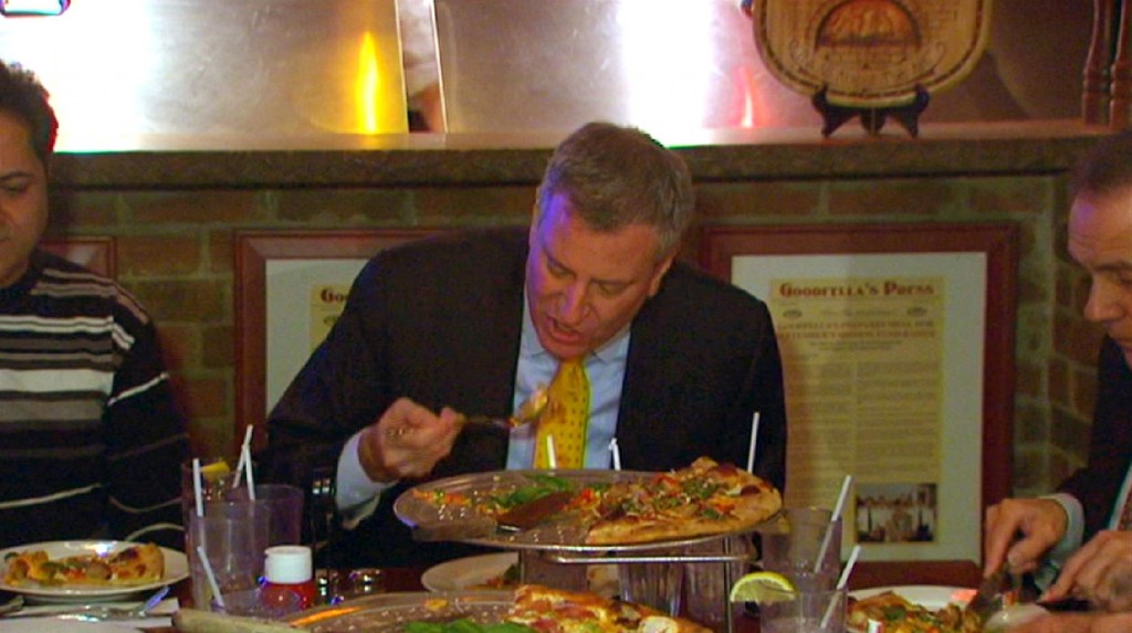 In this image taken from video and provided by New York City Hall, New York Mayor Bill de Blasio eats pizza with a fork at Goodfellas Pizza on Staten Island on Friday. Photo: AP