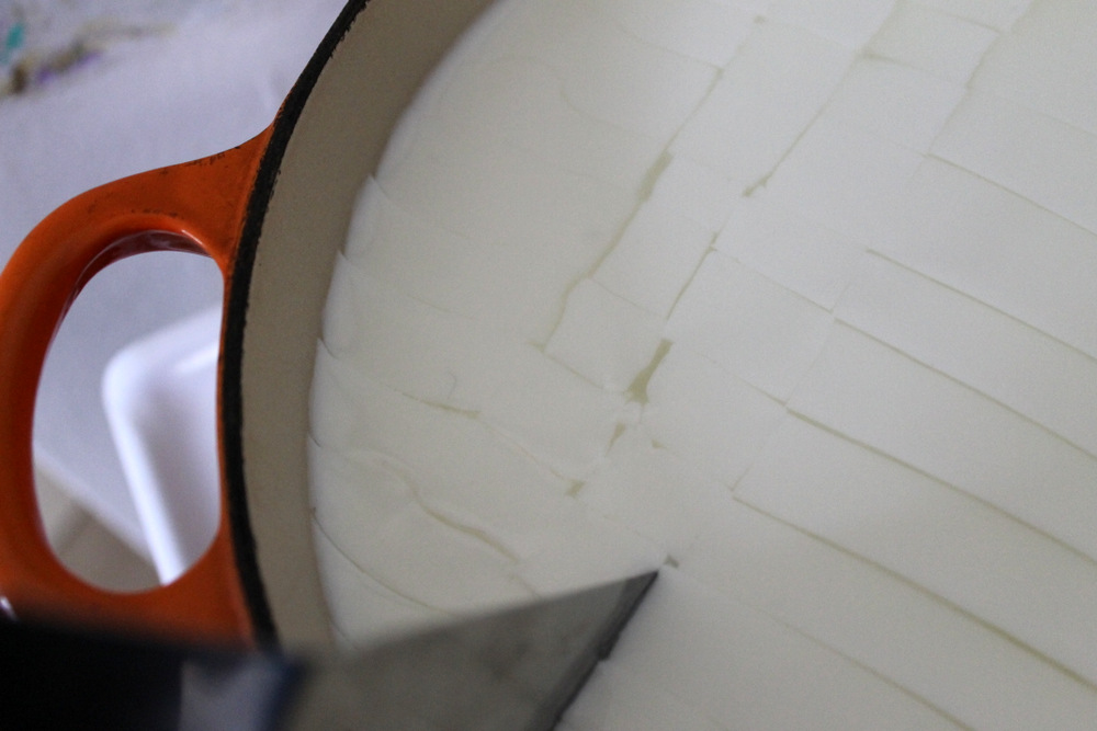 Cutting the curd into small cubes allows it to release whey and form solid cheese. Photo: Kate Williams