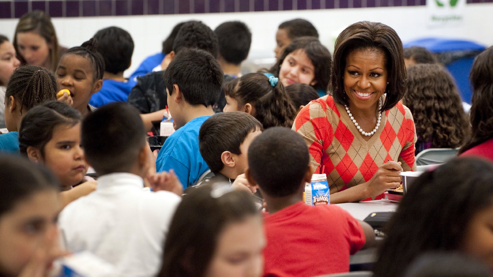 Michelle Obama eats lunch with school children at Parklawn Elementary School in Alexandria, Va., in 2012. The first lady unveiled new guidelines Tuesday aimed at cracking down on the marketing of junk food to kids during the school day. Photo: Saul Loeb/AFP/Getty Images
