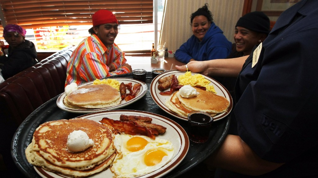 A Denny's waitress delivers breakfast to customers in Emeryville, Calif. The tipped minimum wage has been stuck at $2.13 since 1991. Photo: Justin Sullivan/Getty Images