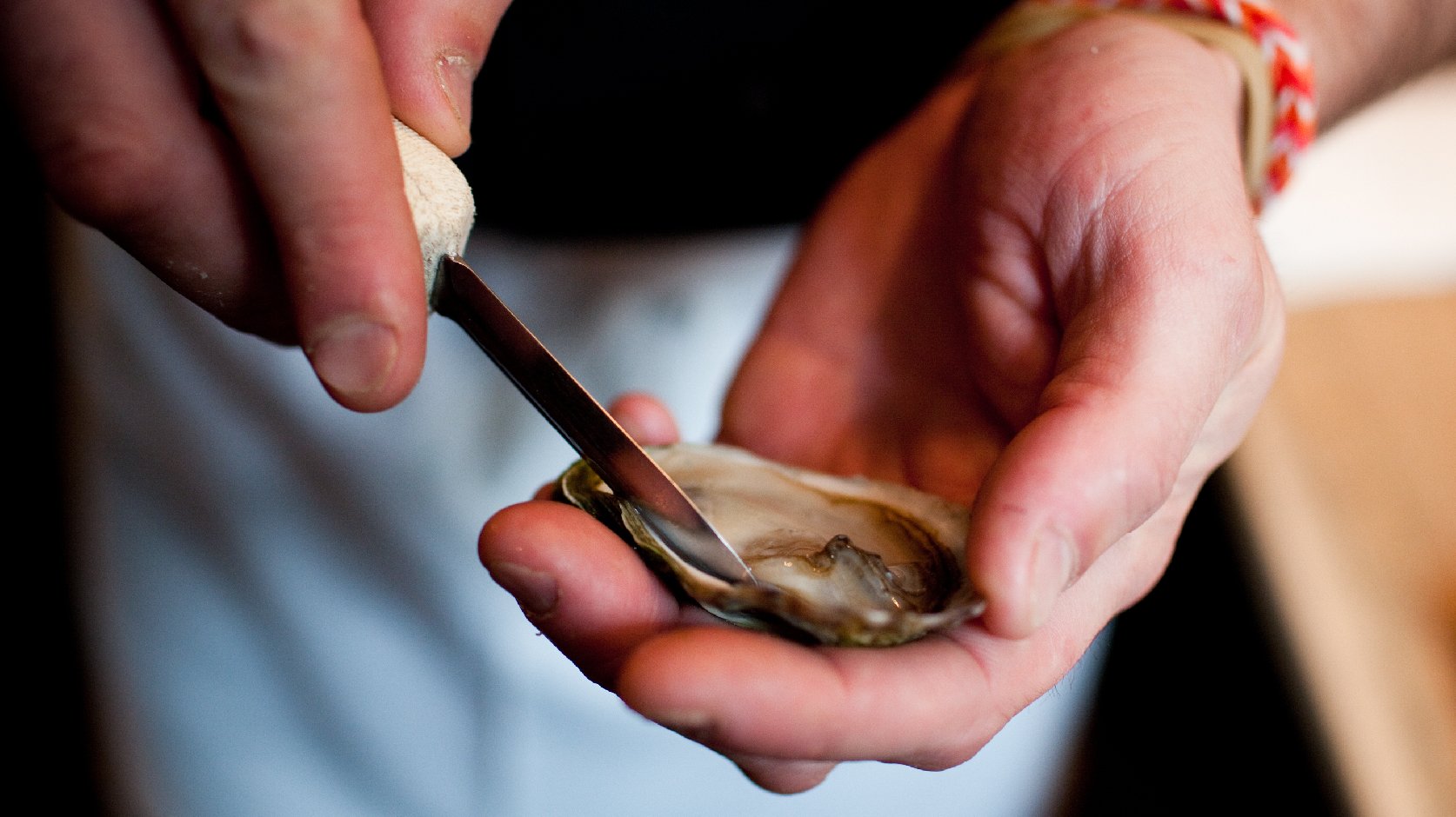 Then slice along bottom, make sure you hold steady to preserve the liquor inside. Your oyster will now slide right off.