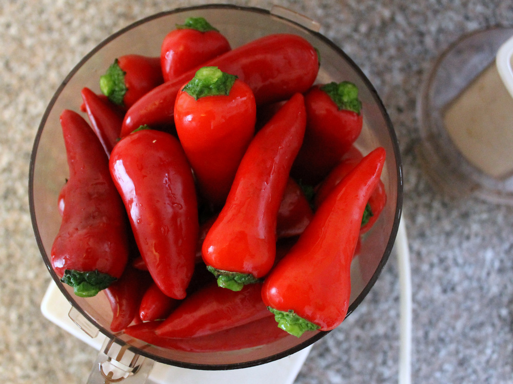 Use easy-to-find red Fresno chiles for a medium-hot sauce, or add spicier chiles, like habaneros, for a more daring blend. Whichever you choose, pulse them to a mash in a food processor. Photo: Kate Williams