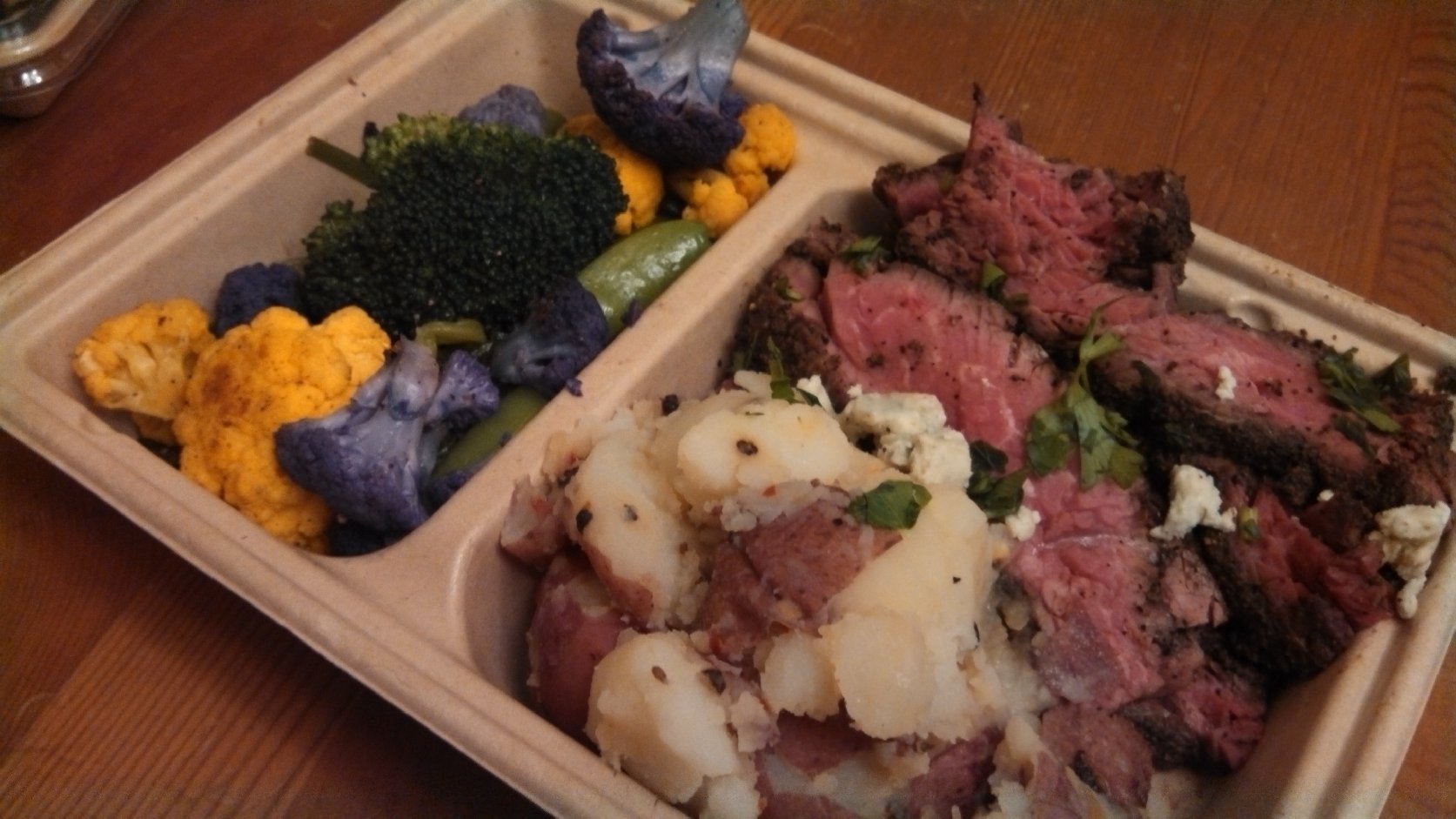 The steak and potatoes didn't look like much in its tray. Photo: Kelly O'Mara